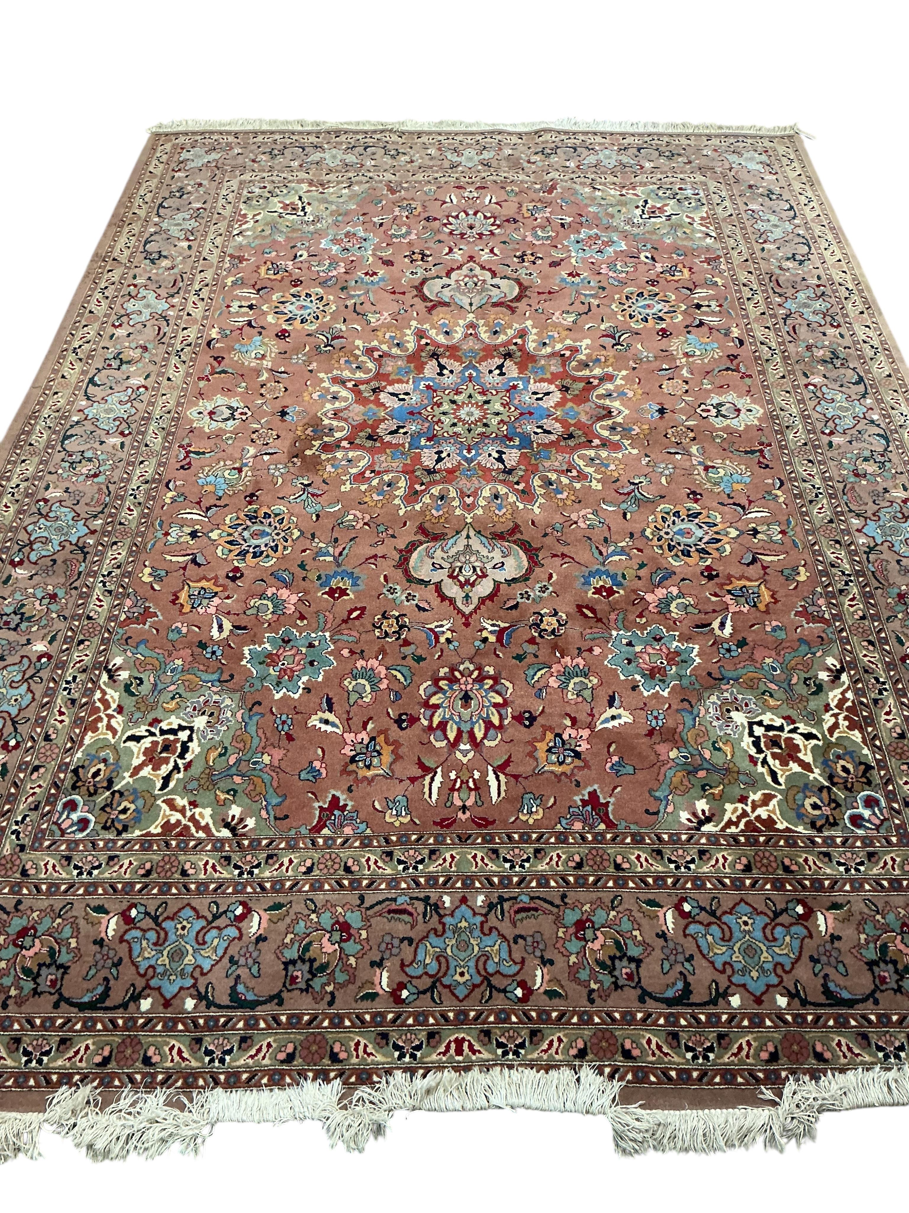 A Tabriz peach ground carpet, 292 x 205cm